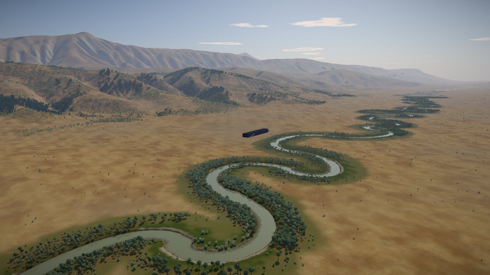 The valley from the air in the morning: a river winds in tight loops across the broad, dry floor with trees along its banks, wooded hills and mountains rise beyond, and the ark stands small and dark on its site beside the river.